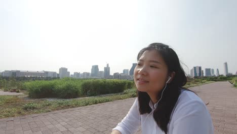 an asian woman in public park.