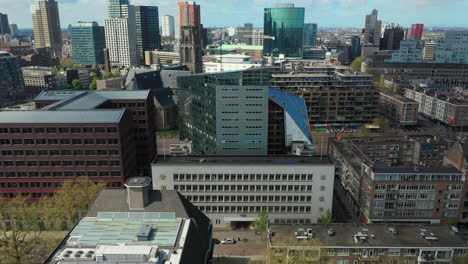 educational institution and city building along botersloot in rotterdam netherlands with world trade center tower in distant background