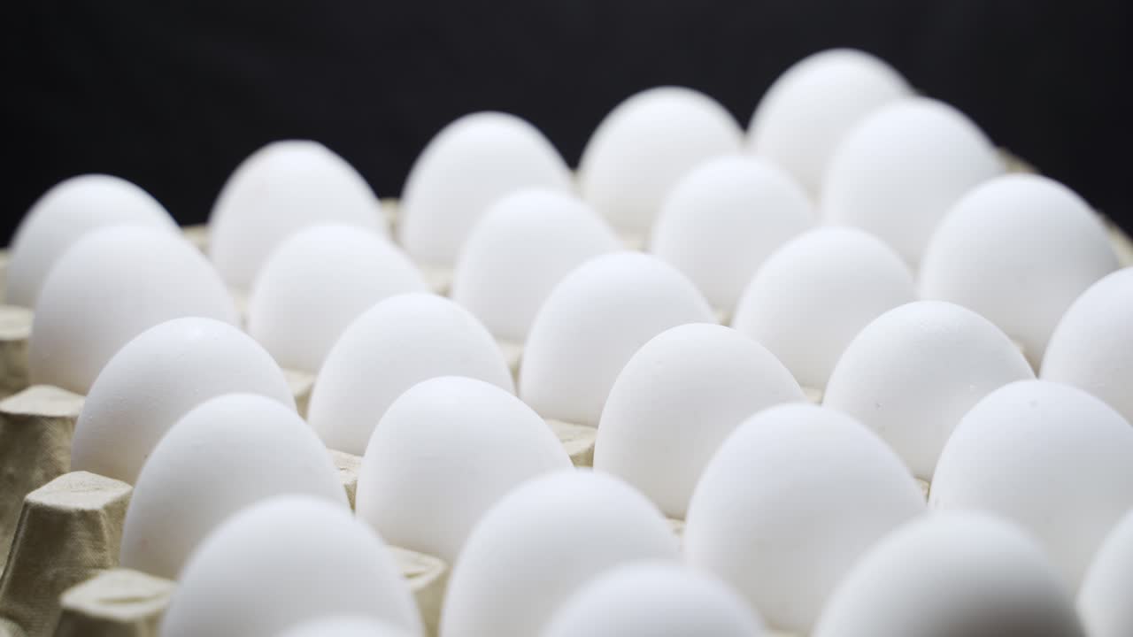 White chicken eggs in a cardboard box. Eggs in a paper tray.