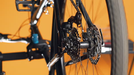 Professional-screwing-bolts-on-bike-parts,-mending-rear-derailleur-and-cassette