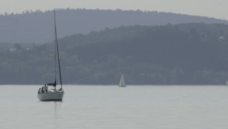 Un-Velero-Privado-Moviéndose-Lentamente-Hacia-El-Lado-Derecho-Con-Los-Viajeros