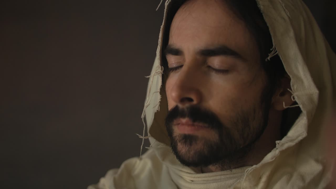 Jesus Christ in ambient light holding bread for communion, Passover, last supper for Christianity stock footage