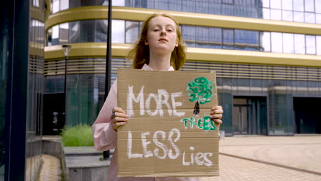 cute redhead holding a placard and protesting 1