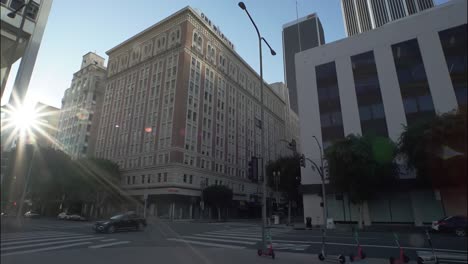 la offices, hotels, apartments. sun rays shine next to modern skyscrapers in downtown los angeles. la is a big financial business city. timelapse