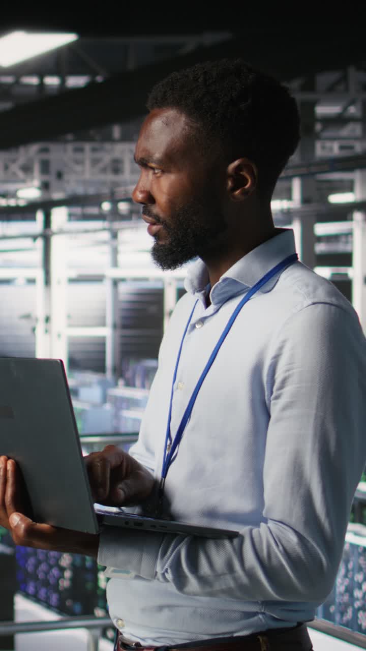 Vertical video Engineers in data center use laptop to monitor neural network LLM visualization