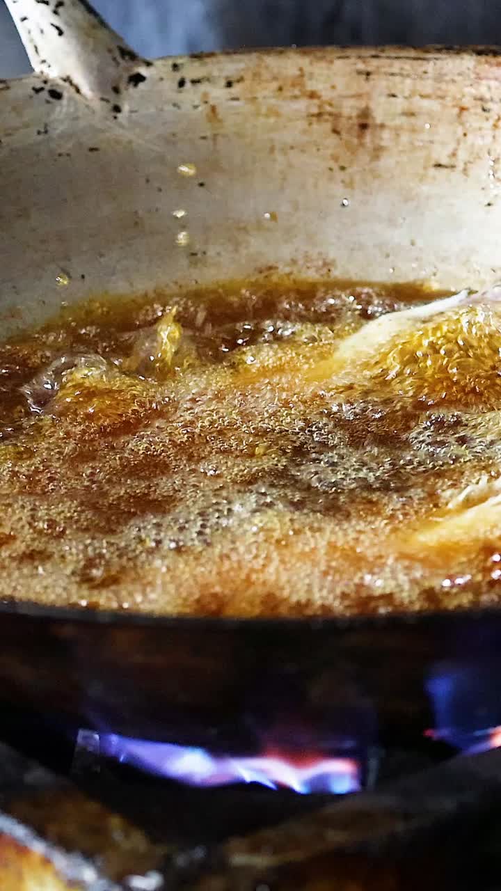 Sequential frying of fish in a hot pan