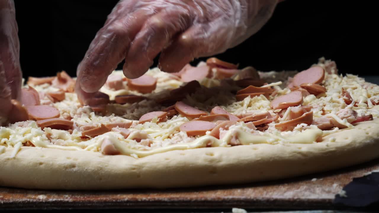Il cuoco sta preparando una pizza.