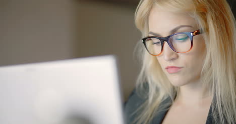 Businesswoman-Working-On-Notebook-In-Office-