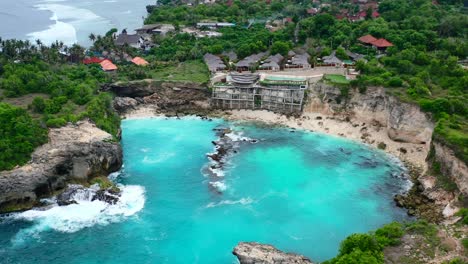 natural blue lagoon with rocky beach at tropical nusa ceningan island in indonesia, aerial