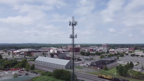 Spiral-Aerial-drone-footage-of-a-cell-phone-tower-in-Muskogee,-Oklahoma