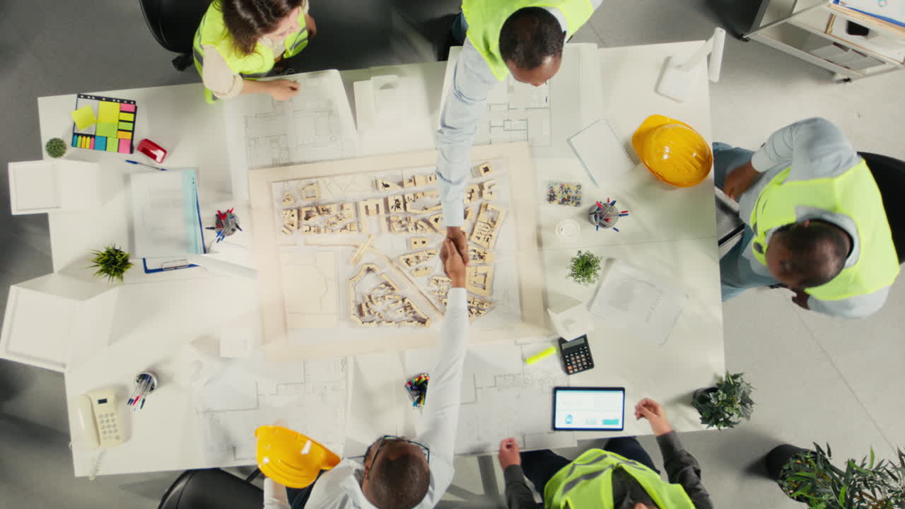 Vertical Video Top down view zoom in of developers and architects in business meeting