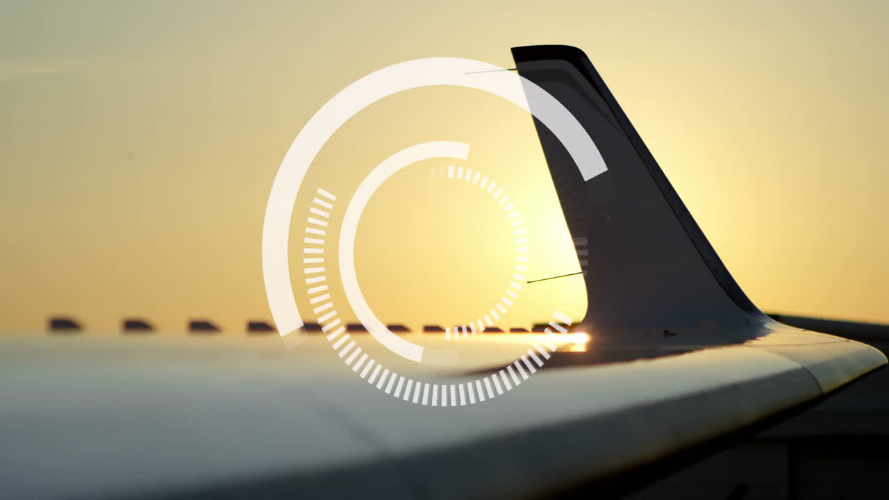 Airplane wing with digital interface animation during sunset in sky