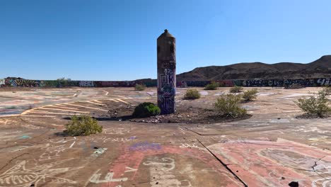 abandoned graffiti-covered concrete landscape in a desert