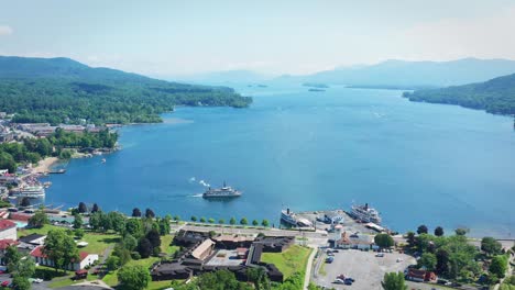 a drone with a birdseye view tilts up and flies lower over lake george and the town of lake george, new york