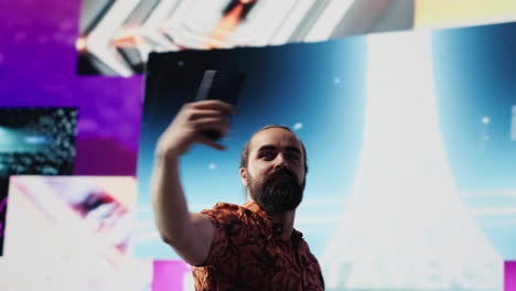 cool relaxed guy using his smartphone under neon lights