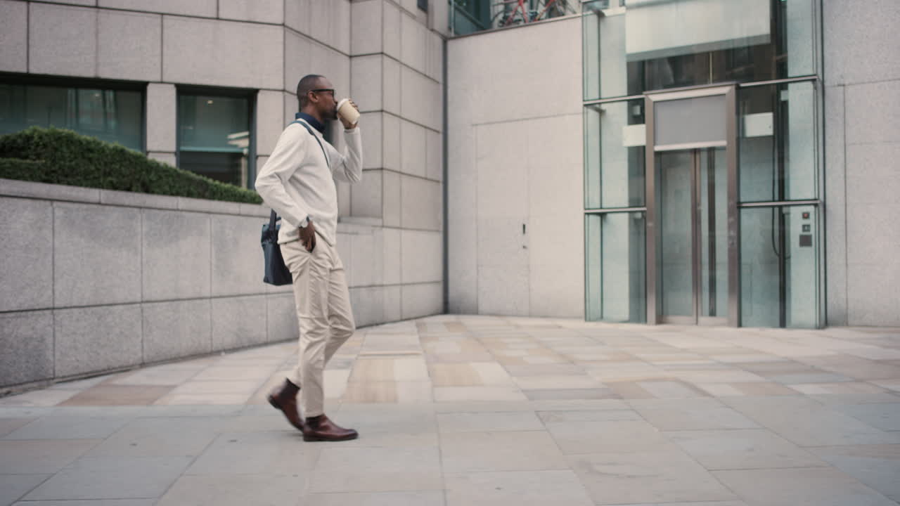 African American businessman walking through city