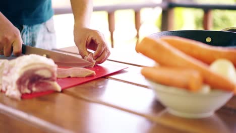 close-up travelling young guy is cooking pilaf he is in summer house