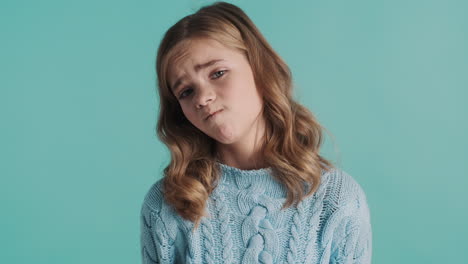 teenage caucasian girl looking sad in front of the camera.