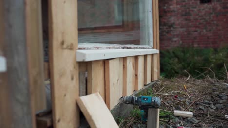 man installing wood planks on doorway