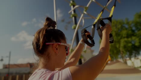 woman working out outdoors using resistance bands