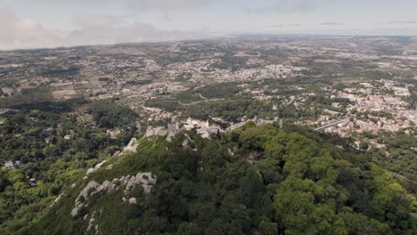 cinematic dolly in overlooking at castle of the moors and reveals town palace in far distance