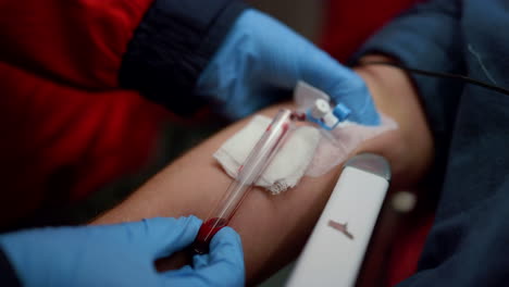 paramedic taking sample for blood test. doctor providing medical help to man