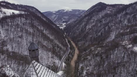 Flying-beside-the-Kuslat-Mosque-from-the-ottoman-period-in-Bosnia-and-Herzegovina-with-a-beautiful-canyon-landscape