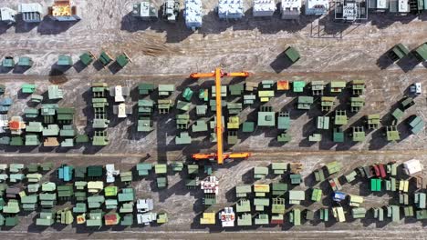 an aerial view of a slow-moving gantry crane surrounded by transformers at maddox industrial transformer in south carolina.