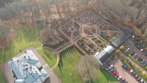 Drone-flyover-large-country-mansion-house-and-formal-gardens-in-autumn