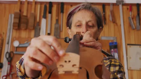 female luthier at work in her workshop