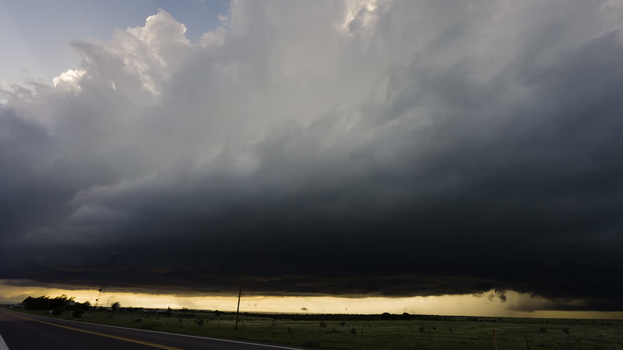 Towering Clouds Build Overhead As Dark Storm Base Moves Across The Sky