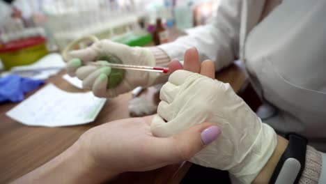 Closeup-view-of-blood-analysis-from-finger.-Medical-hand-taking-blood-from-finger.-Finger-needle-puncture.-Test-blood-sample.-Shot-in-4k