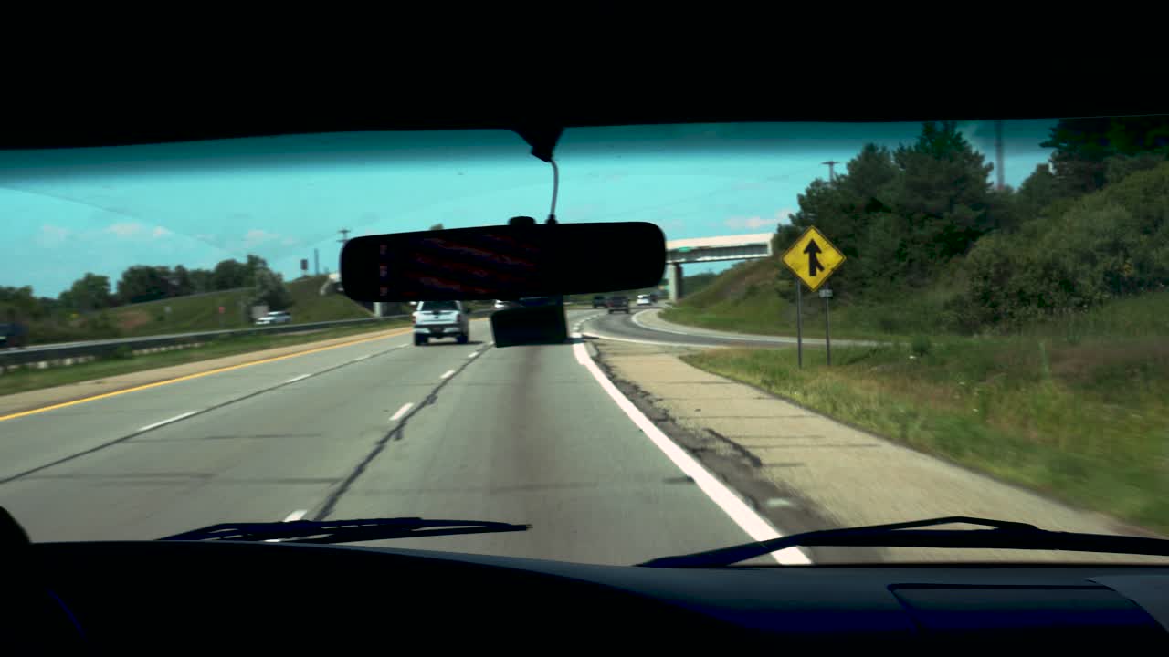 A man pilots a coachmen santara down a highway in summer of 2020