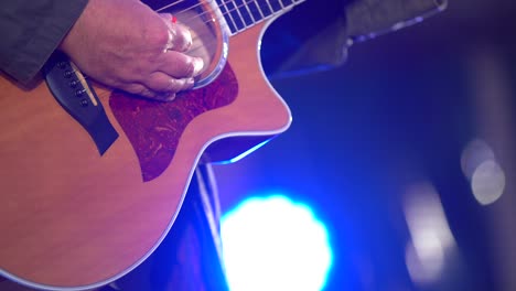 hands of man playing electric guitar. bend technique. low key photo.