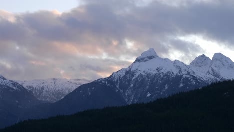 sunset clouds over snow-capped mountains. static shot