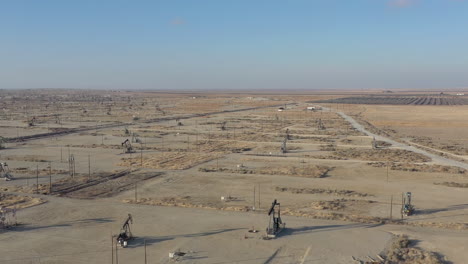 wells with pump jacks on oil field, california usa