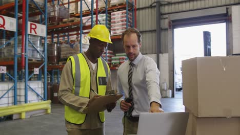 male warehouse manager and warehouse worker in loading bay 4k