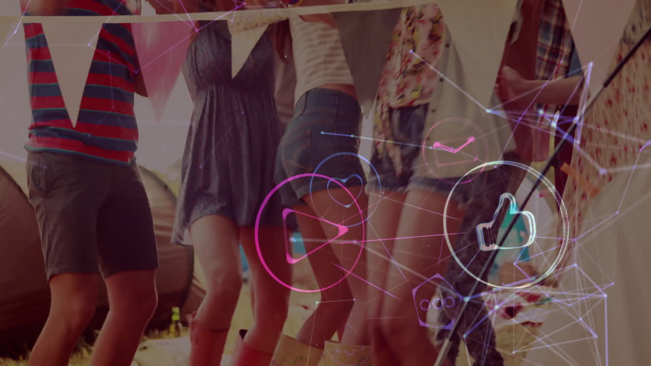 Dancing people at outdoor event with social media interaction animation over them