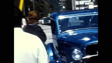 vintage car parked on roadside at 1970s old car show in usa. circa usa - 1970s: a classic, old fashioned car is seen parked on the side of the road at a vintage car show in the united states during the 1970s.