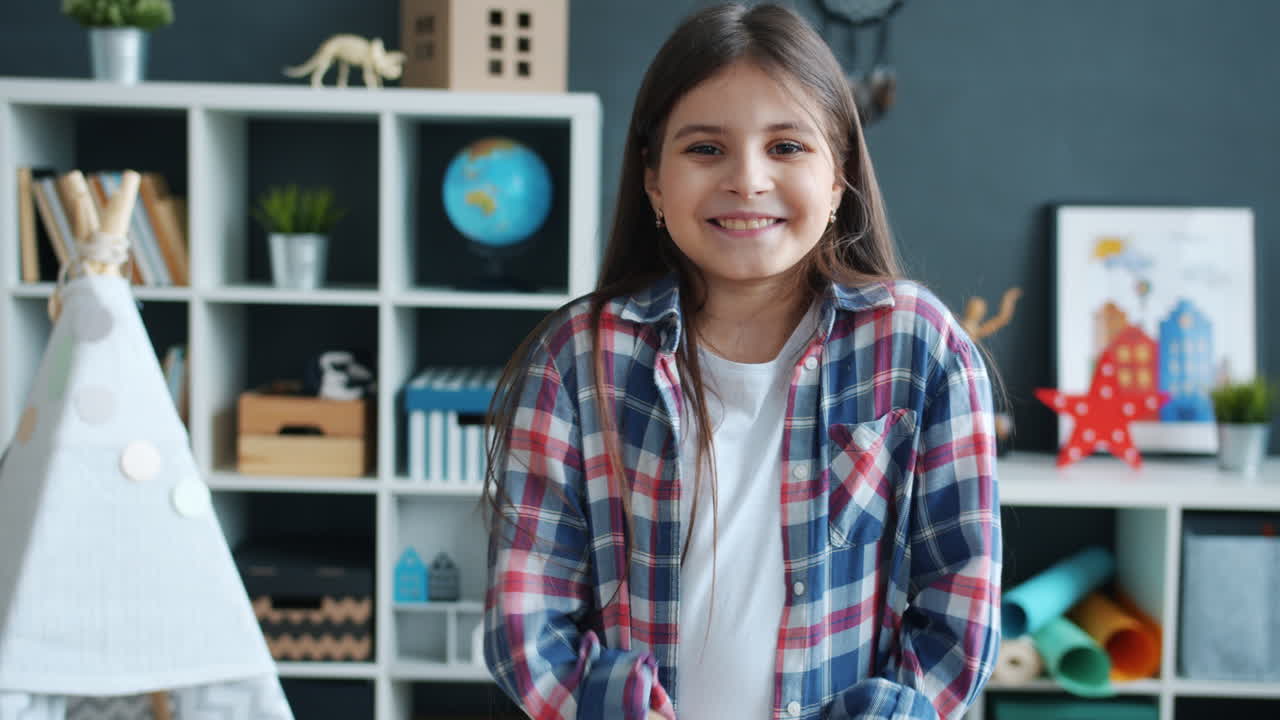 Happy Girl Clapping in a Playroom