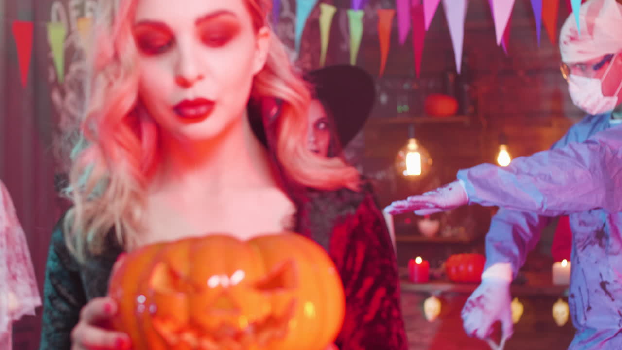 Halloween Party with Woman Holding Pumpkin