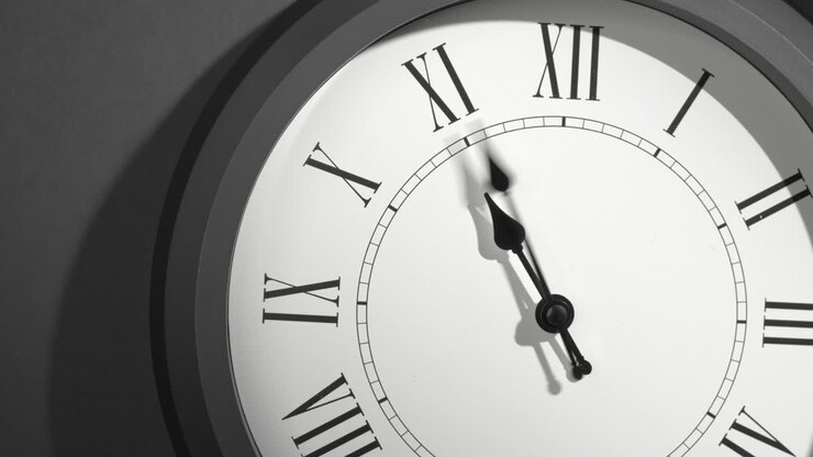 Latin Clock Face in Time Lapse on Dark Grey Wall