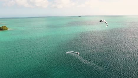 two men friends flying kitesurf on turquoise sea water, stunning landscape los roques