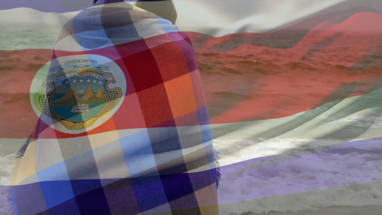Wrapped in colorful blanket, people by ocean with flag and emblem animation