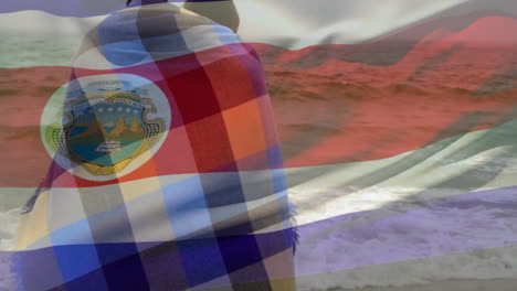 wrapped in colorful blanket, people by ocean with flag and emblem animation