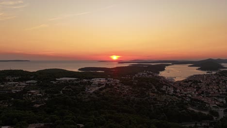 capture the stunning beauty of mali lošinj during golden hour, as the sunset lights up the sky and the coastline. this aerial footage highlights the peaceful charm of the island