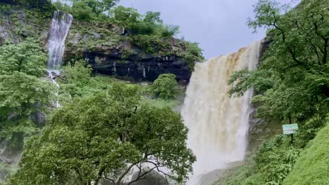 the mesmerizing koltembha waterfalls in bhandardara cascade gracefully amid a dense green forest surrounded by mist and the monsoon’s refreshing aura maharashtra india