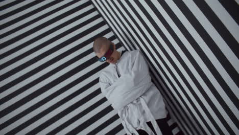 man in a straight jacket with digital glasses