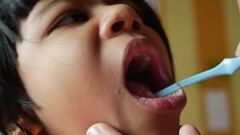 child getting teeth brushed