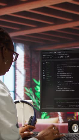vertical video programmer types code into pc, entering commands, running script